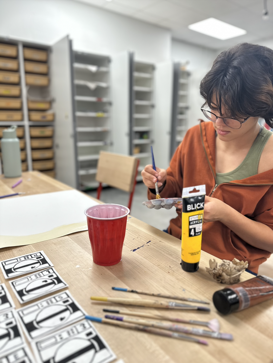 Senior Isabella Cabrera works on prepping paint for one of her pieces in Art teacher Nathan Fry's class. This activity allowed students to use their imagination with their artwork. ”I’m doing a visual representation of washing mashing heart by Mitski,” Cabrera said. “I’m looking forward to the finished product.”